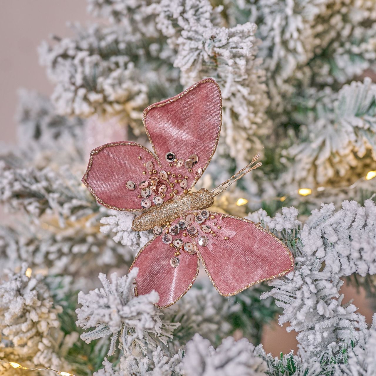 Introducing the Velvet Tree Decoration - Butterfly with Clip by The Seasonal Gift Co. Exquisite and delicate, this butterfly ornament adds a touch of elegance to any holiday display. Crafted from luxurious velvet, it radiates sophistication and charm.