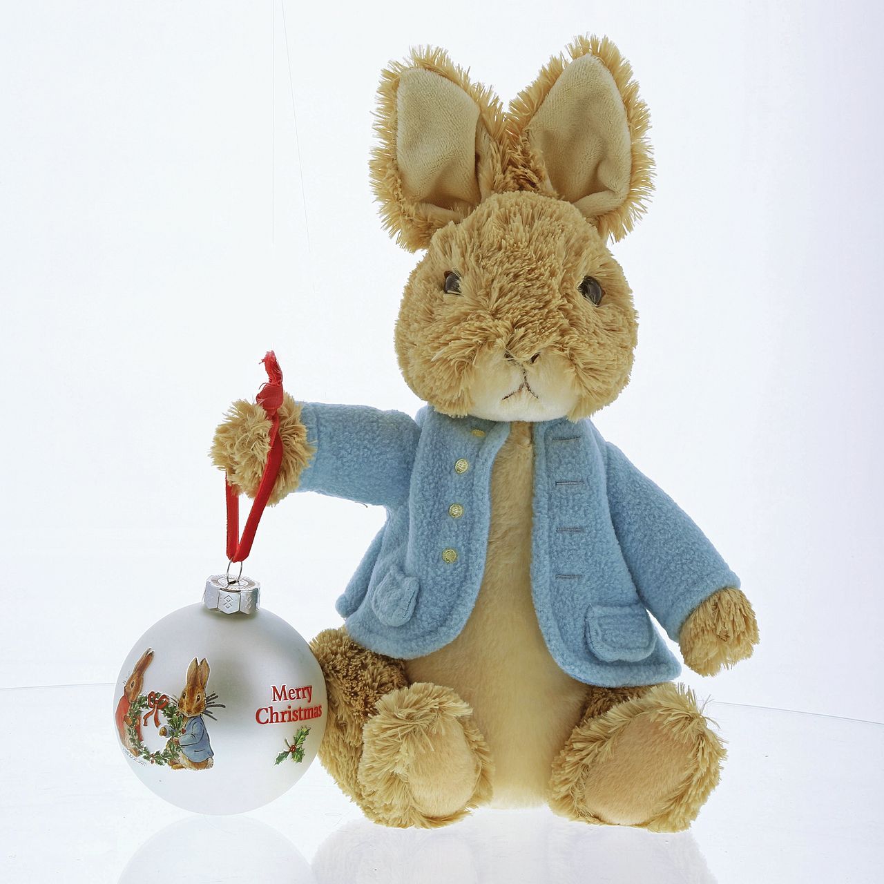 Beatrix Potter Peter Rabbit and Flopsy Holding Holly Wreath Bauble  Add a touch of Beatrix Potter to your Christmas tree, with this winter collection inspired bauble. This Peter Rabbit and Flopsy Holding Holy Wreath bauble would make a heart-warming Christmas gift. 