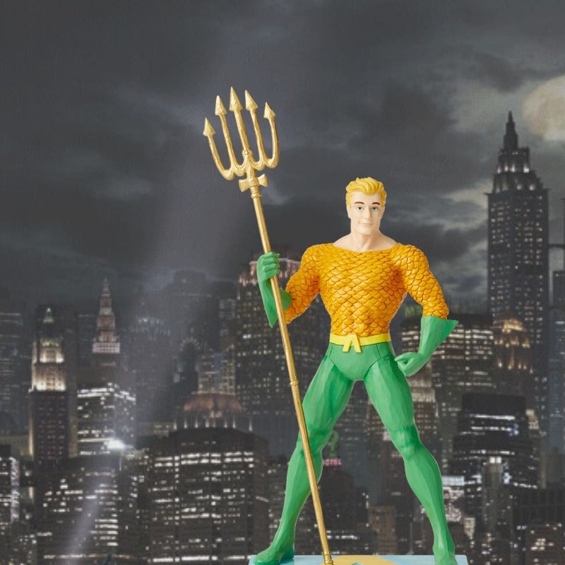 Jim Shore King of the Seven Seas - Aquaman Silver Age Figurine  DC Comics Justice League is a comprised of the worlds most iconic superheroes. Jim Shore celebrates Aquaman in an iconic pose in his signature wood carved look and folk art styling.