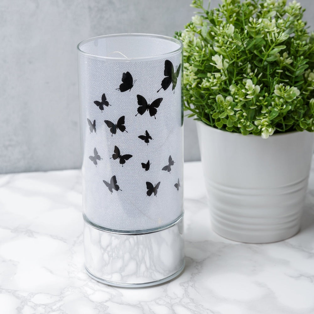 HESTIA® Glass Butterfly Design Tube with LED Lights 20cm  A beautiful LED tube from HESTIA®'s Silver Luxe collection. Featuring a dazzling glitter finish with butterfly design on a metal base. Requires 3 x AA batteries for use.