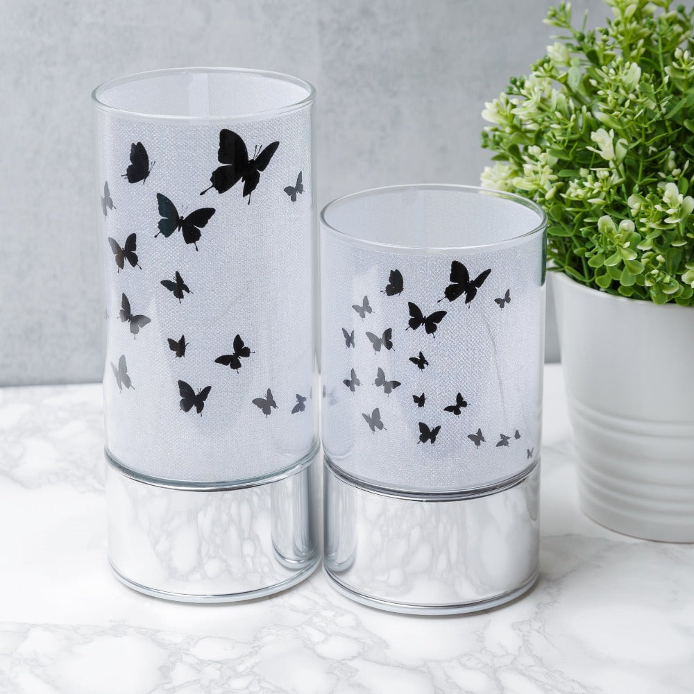 HESTIA® Glass Butterfly Design Tube with LED Lights 20cm  A beautiful LED tube from HESTIA®'s Silver Luxe collection. Featuring a dazzling glitter finish with butterfly design on a metal base. Requires 3 x AA batteries for use.