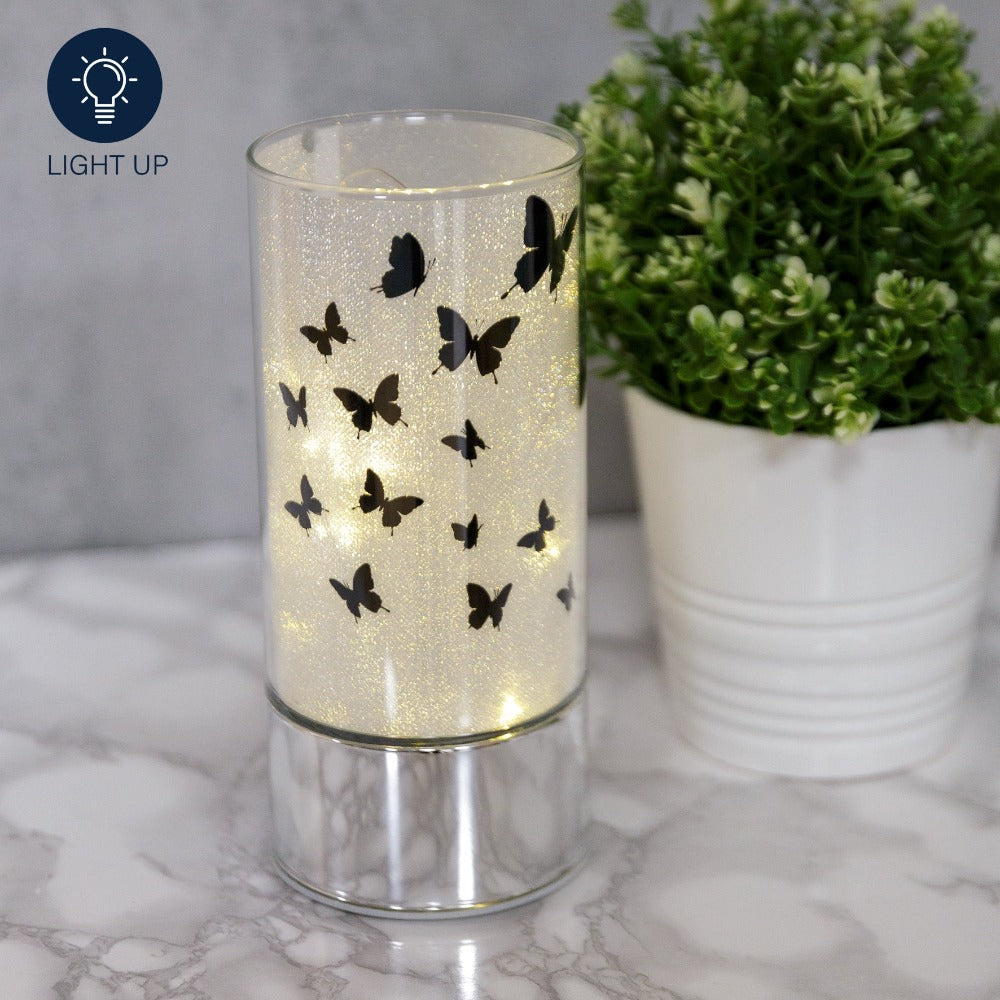 HESTIA® Glass Butterfly Design Tube with LED Lights 20cm  A beautiful LED tube from HESTIA®'s Silver Luxe collection. Featuring a dazzling glitter finish with butterfly design on a metal base. Requires 3 x AA batteries for use.