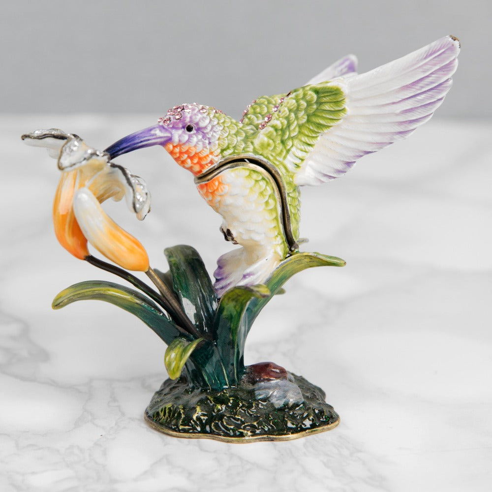 Treasured Trinkets Hummingbird  A beautiful, hand painted and crystal finished hummingbird trinket box from Treasured Trinkets.  Painted in the ethereal colours of a enchanting hummingbird, this trinket box is a wonderful ornament to complement a mantelpiece, bookcase or cabinet.